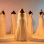 A luxurious bridal boutique display with multiple elegant wedding dresses on mannequins.