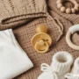 A soft, warm-toned flat lay of baby essentials.