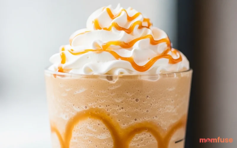 “caramel frappuccino with drizzle inside cup, creamy blended drink”