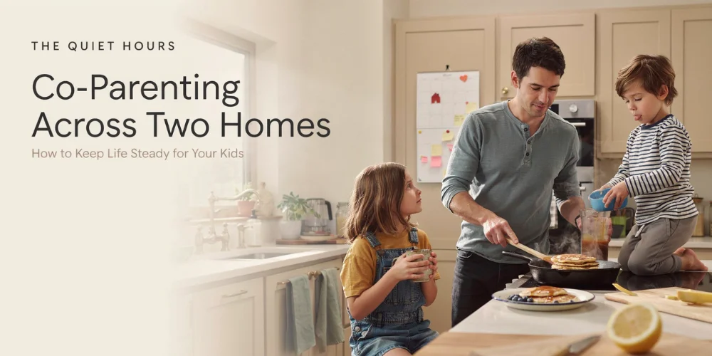 Father cooking breakfast with two children in a kitchen, illustrating co-parenting across two homes.
