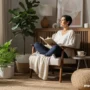 A calm, modern wellness scene showing an woman sitting near a window, holding a notebook.