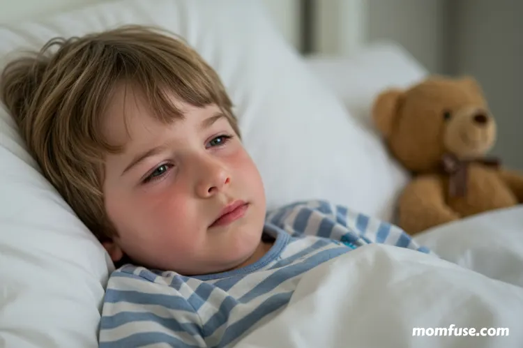 A child lying in bed looking congested.