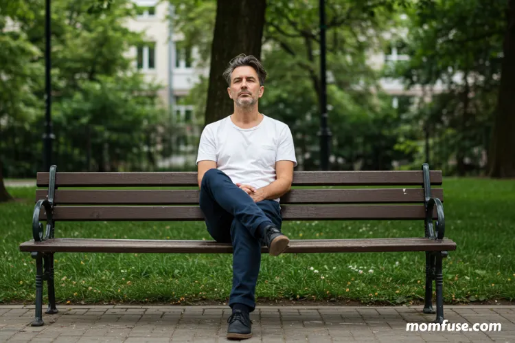 Person sitting quietly on a park bench.