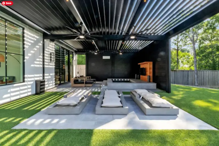 Elegant backyard with a modern aluminum pergola, stylish outdoor sofa set beneath.