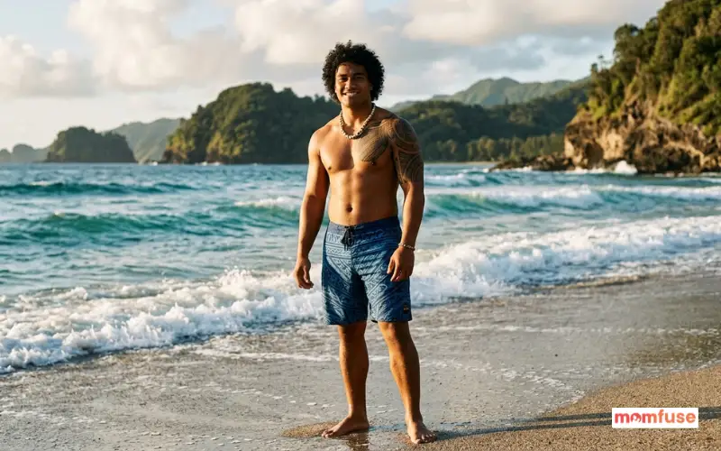 strong islander young man with athletic build, standing near ocean, natural sunlight, relaxed confident expression.