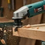 A dynamic image featuring an oscillating tool in action, cutting through a piece of wood.