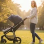A soft, inspiring of a happy new mother walking outdoors with a stroller.