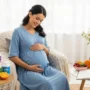 Pregnant woman holding her belly, surrounded by prenatal vitamins and a healthy lifestyle setup.