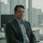 A man sitting calmly in a office.