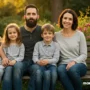 A hopeful family sitting together on a park bench.
