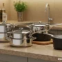 A modern kitchen countertop with a variety of premium cookware items.