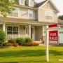 A charming suburban family home with a "For Sale" sign in the front yard.