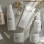 A clean flat lay of self-care essentials — skincare bottles.