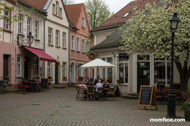 A charming small town in spring, with cobblestone streets, a local coffee shop.