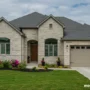 A modern suburban home exterior with a mix of stone veneer styles.