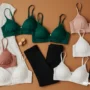 A flatlay of different bras in versatile colors placed next to outfits.