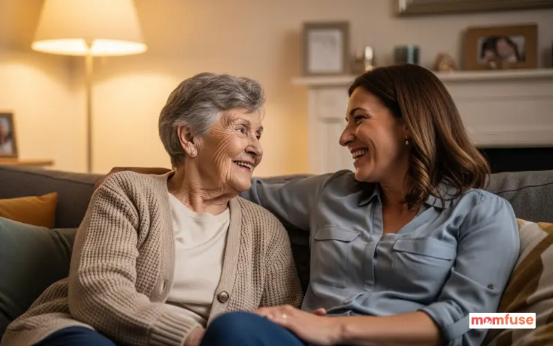 elderly woman smiling while talking with her daughter on sofa, warm family bonding moment, cozy home.