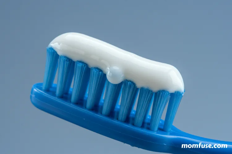 A close-up of a toothbrush with a fluoride toothpaste droplet 