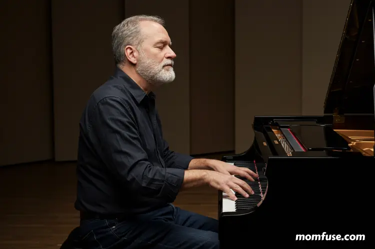 A pianist with closed eyes playing expressively.