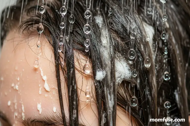 Shower water droplets over hair with mineral residue concept, hard water skincare.