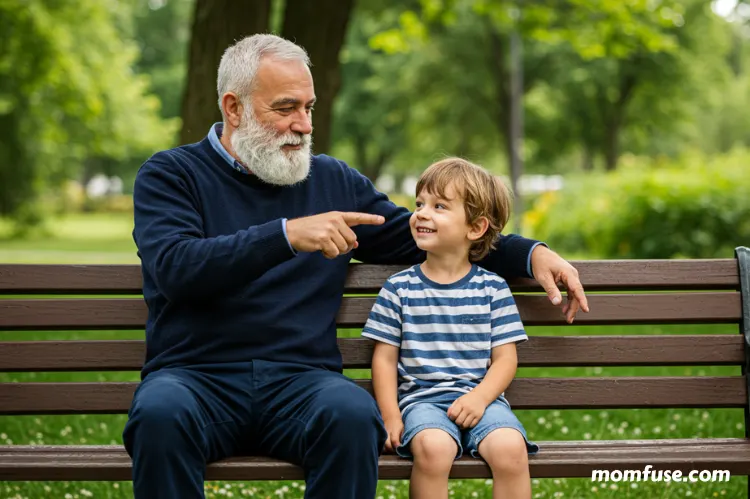 A experienced man and a young child sitting together on a park bench.